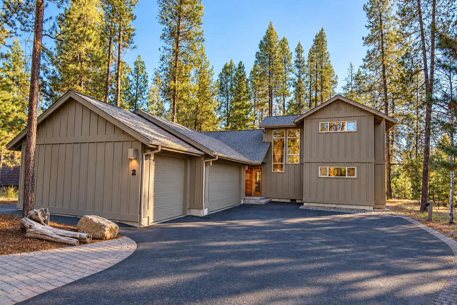 The Sunriver Cabin: board-and-batten home with a three-car garage among tall ponderosa pines