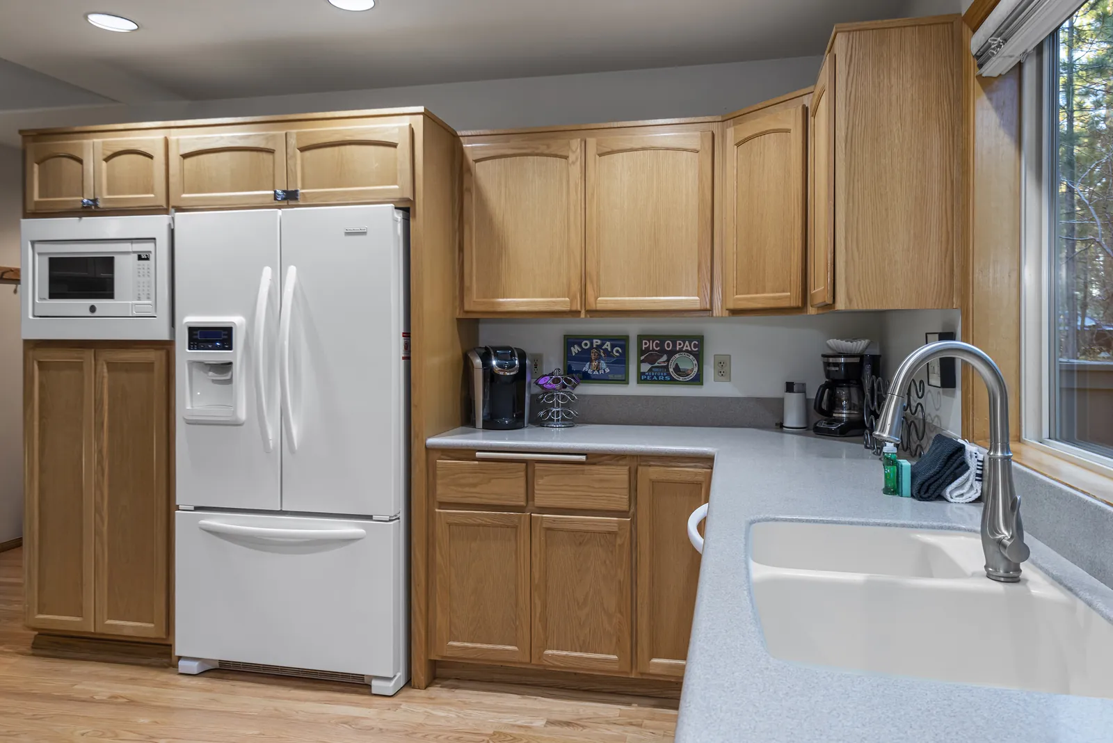 Kitchen with French-door refrigerator, coffee station and a window over the sink