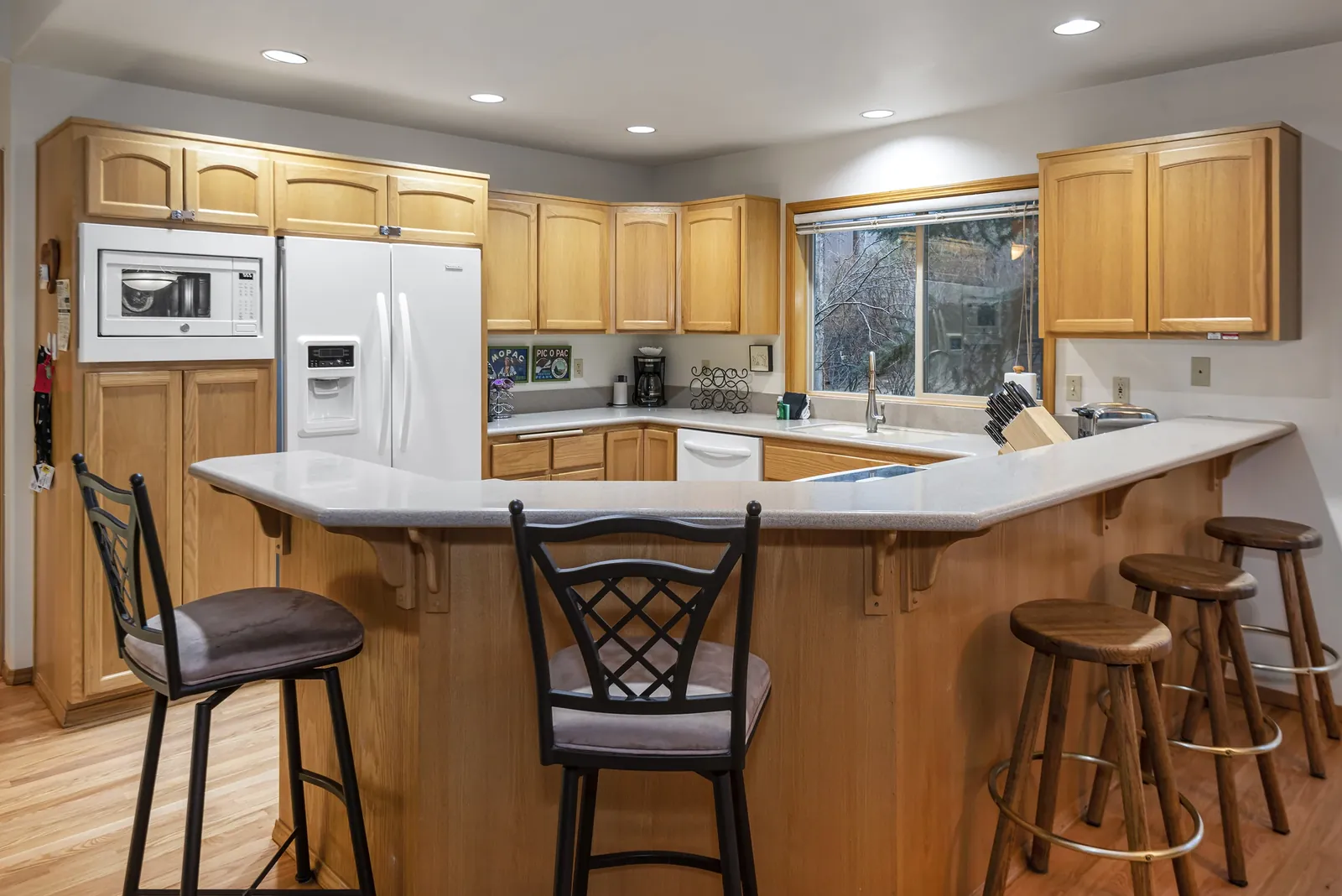 Kitchen with a long breakfast bar and four stools