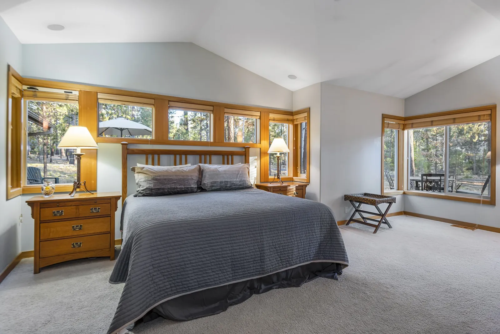 The Cascade Suite: main-floor primary bedroom with king bed and corner windows